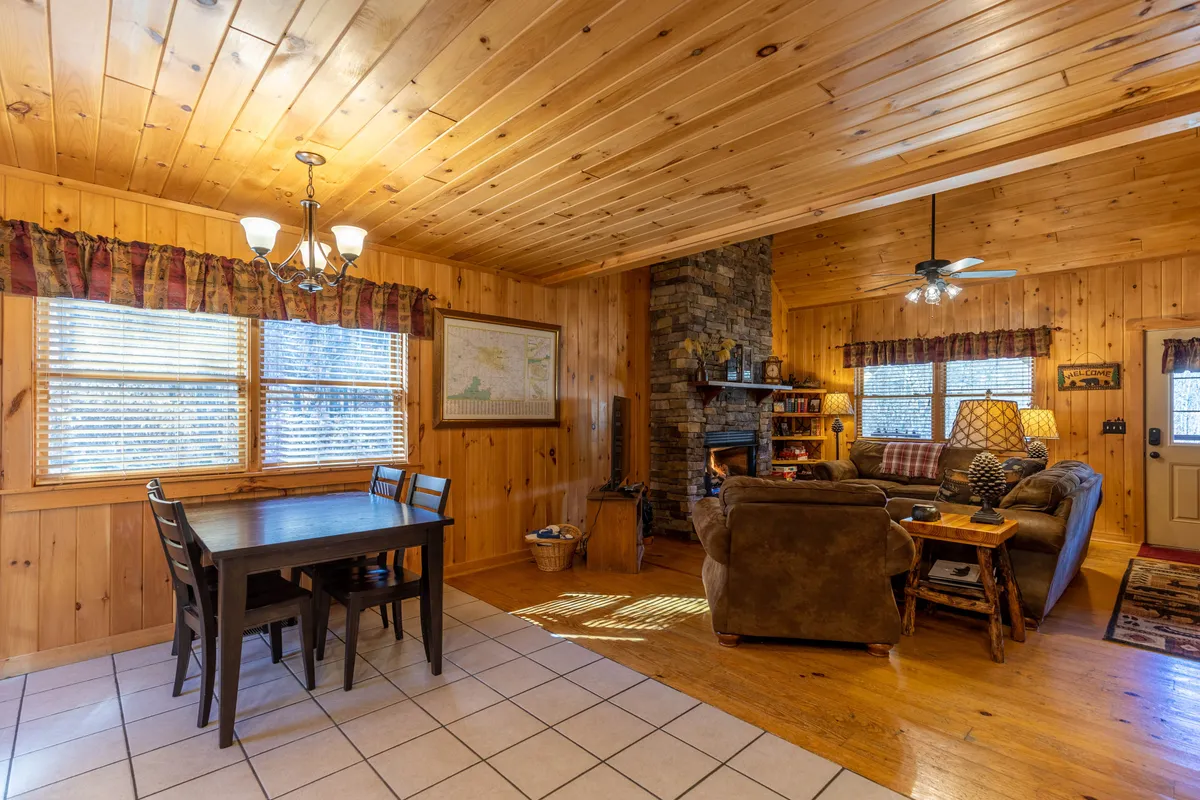 A bright, open dining area centers around a large table, with a fireplace and comfy sofa nearby. The space is designed for shared meals, celebrations, and casual gatherings, underscoring the home’s suitability for hosting groups and creating lasting memories.